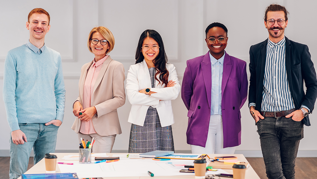 Five professional individual standing and smiling