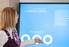 A woman looking at a presentation screen