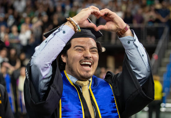 Man holding up a heart sign with this hands
